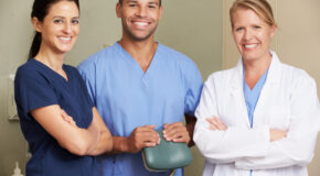 Portrait Of Dentist And Dental Nurses In Surgery